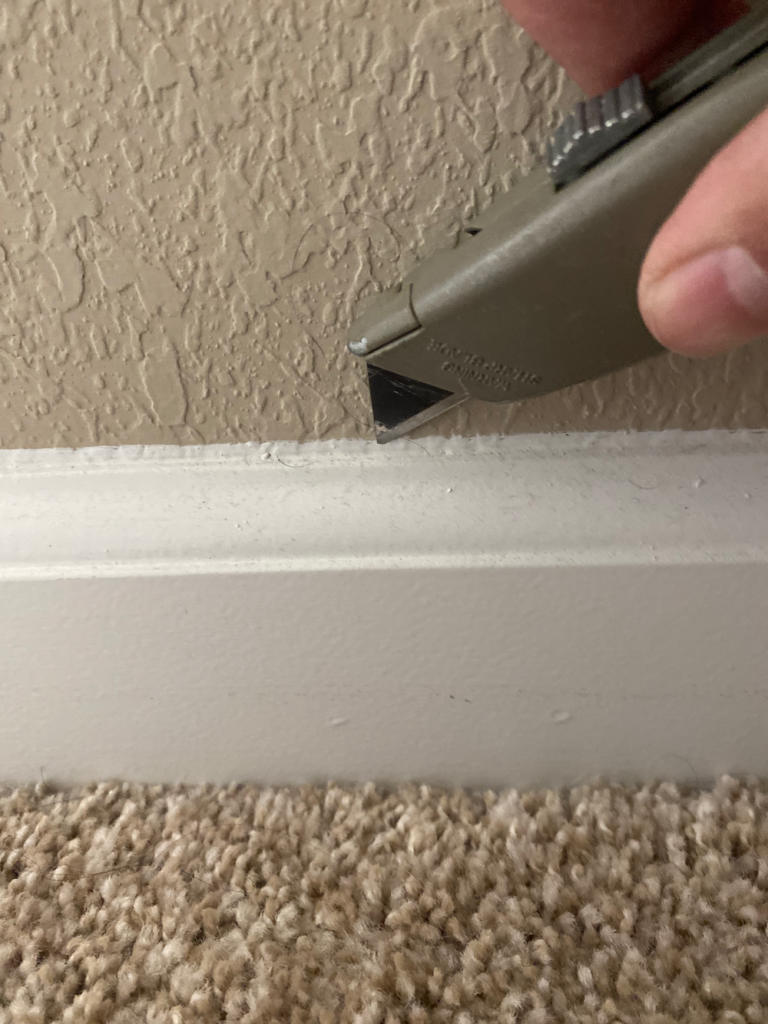 Using a utility knife to score trim