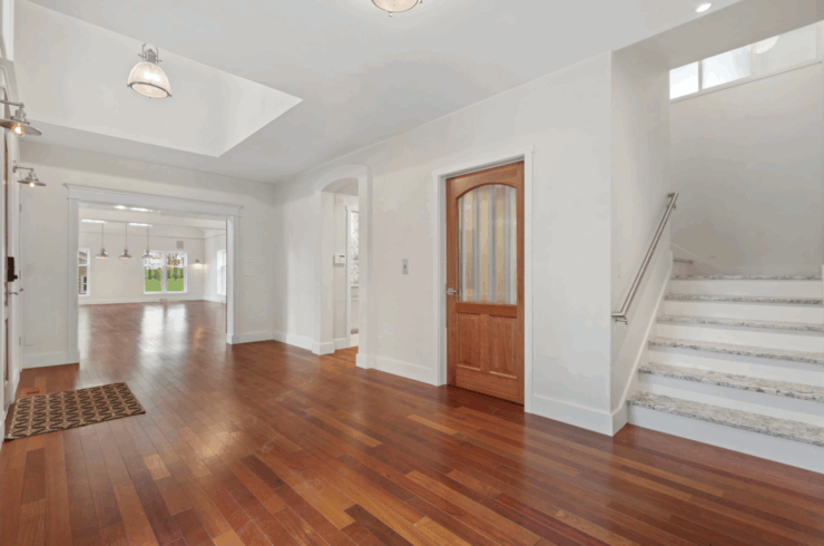 This is the main foyer, with access to the primary bedroom upstairs, the door goes to the elevator, and you an see the entrance to the ball room.