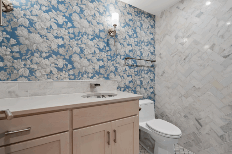 Full en-suite bathroom for Bedroom 1 with custom tile, vanity, and wallpaper.